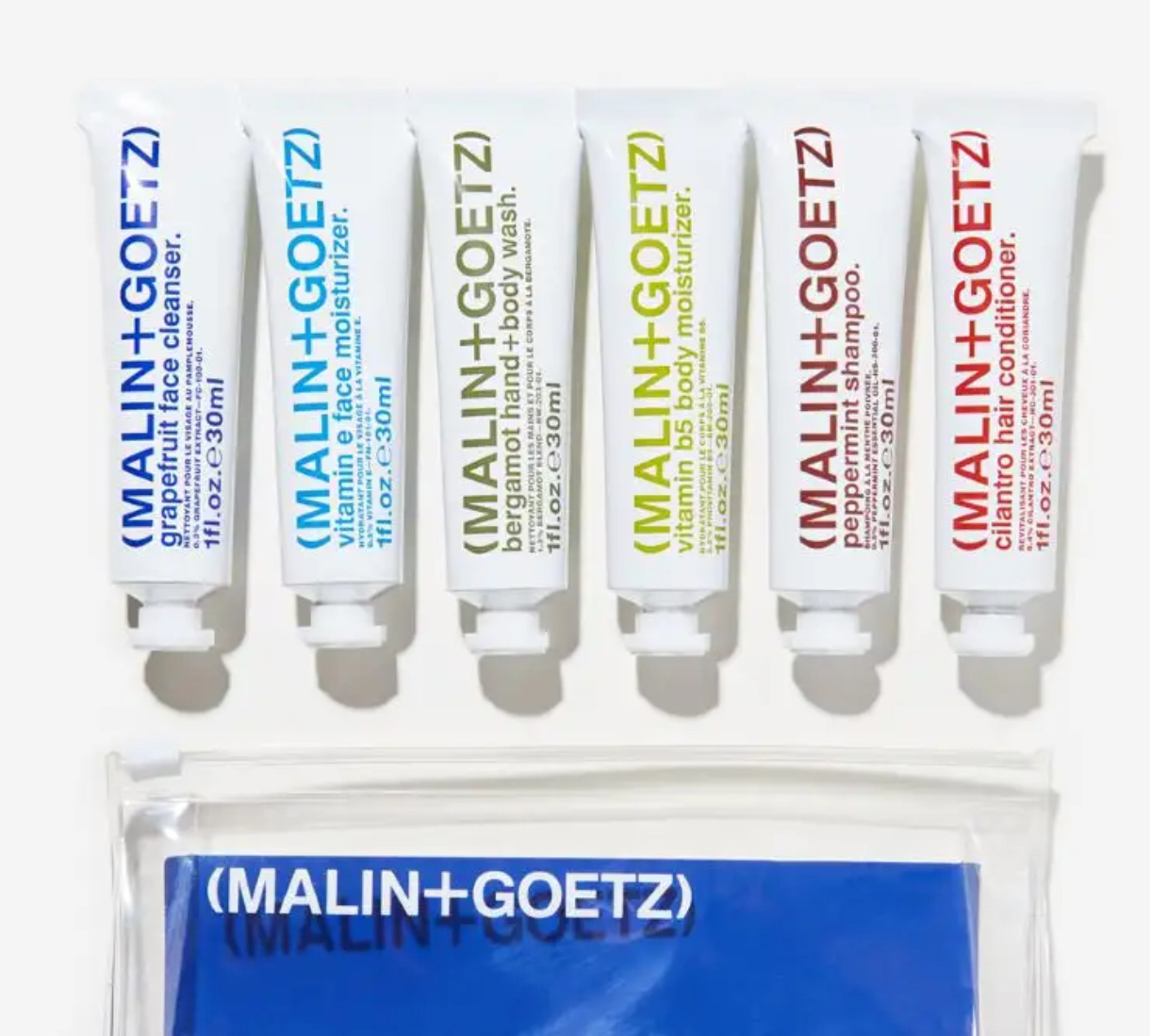 Malin+Goetz face body and hair tubes in multi-color array