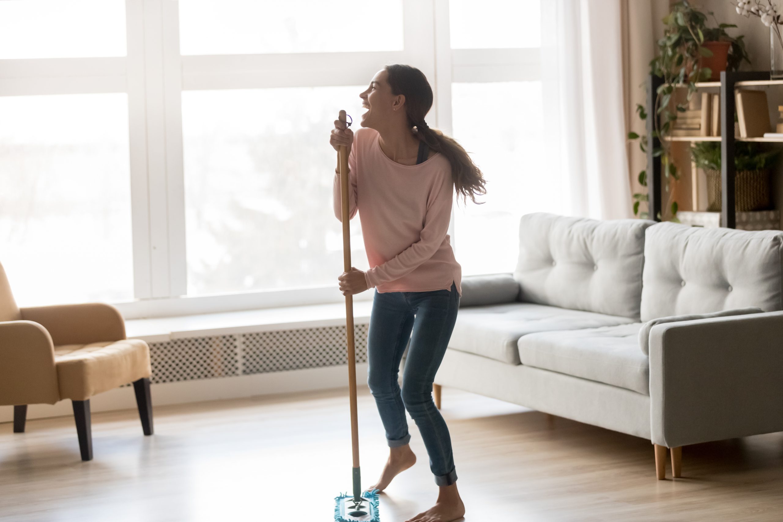 Cary Prince Organizing Your Cleaning Supplies with multiracial girl dancing in living room with broom, and singing into handle as if a microphone