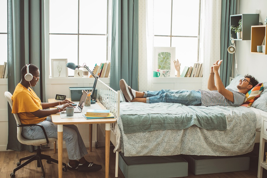 roommates studying in college dorm room