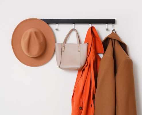 Cary Prince Organizing styles front entryway with coat hat and purse rack